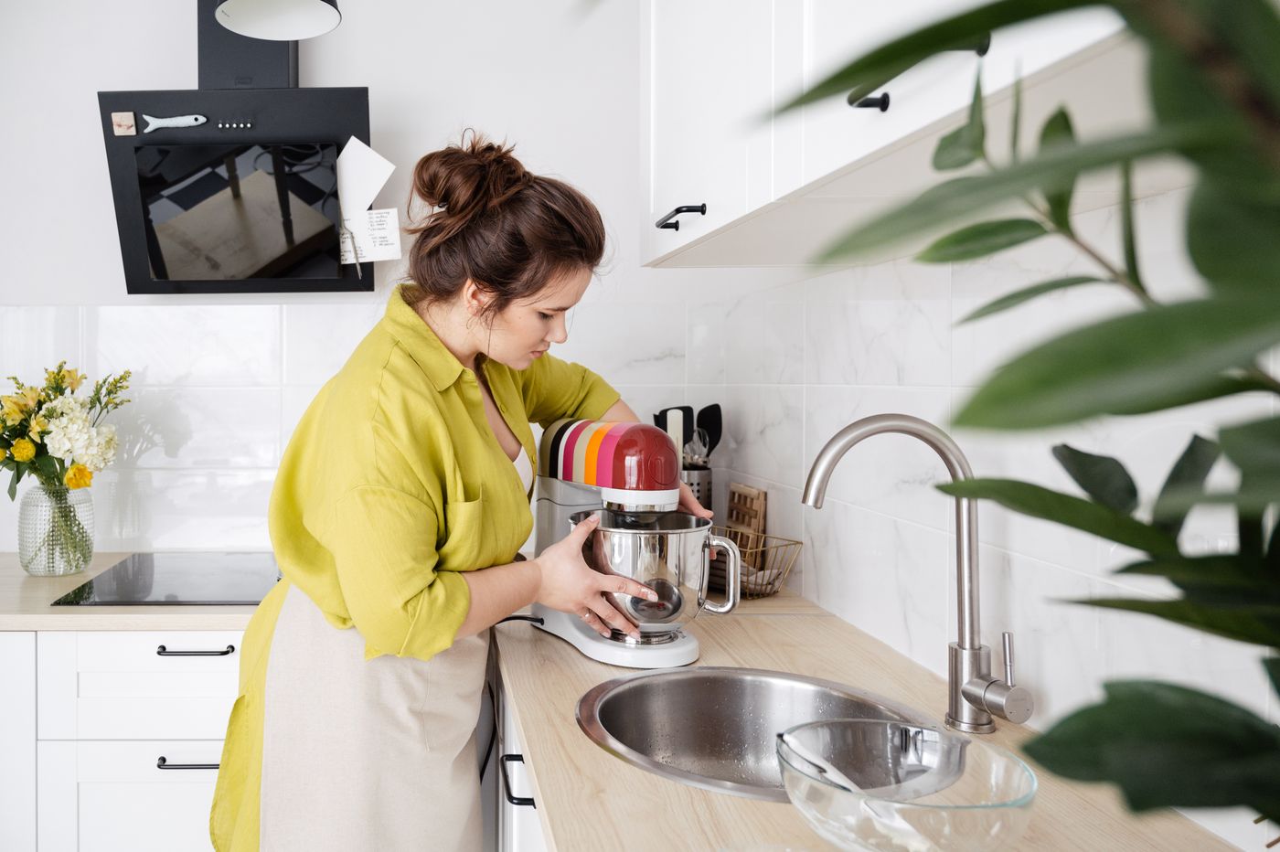 Home cook using a stand mixer in a bright modern kitchen