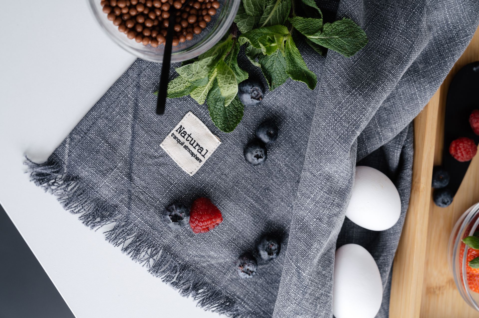 Fresh berries and eggs on crumpled fabric