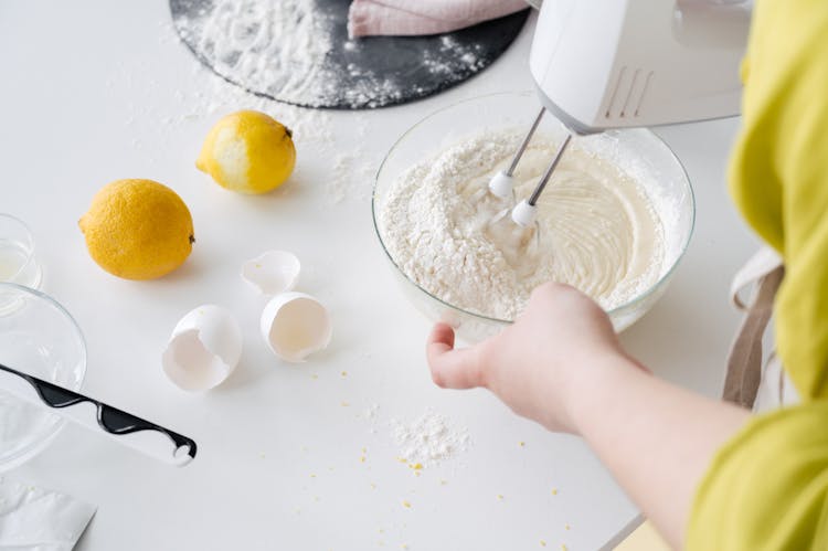 Crop Woman Mixing Cake Dough In Kitchen