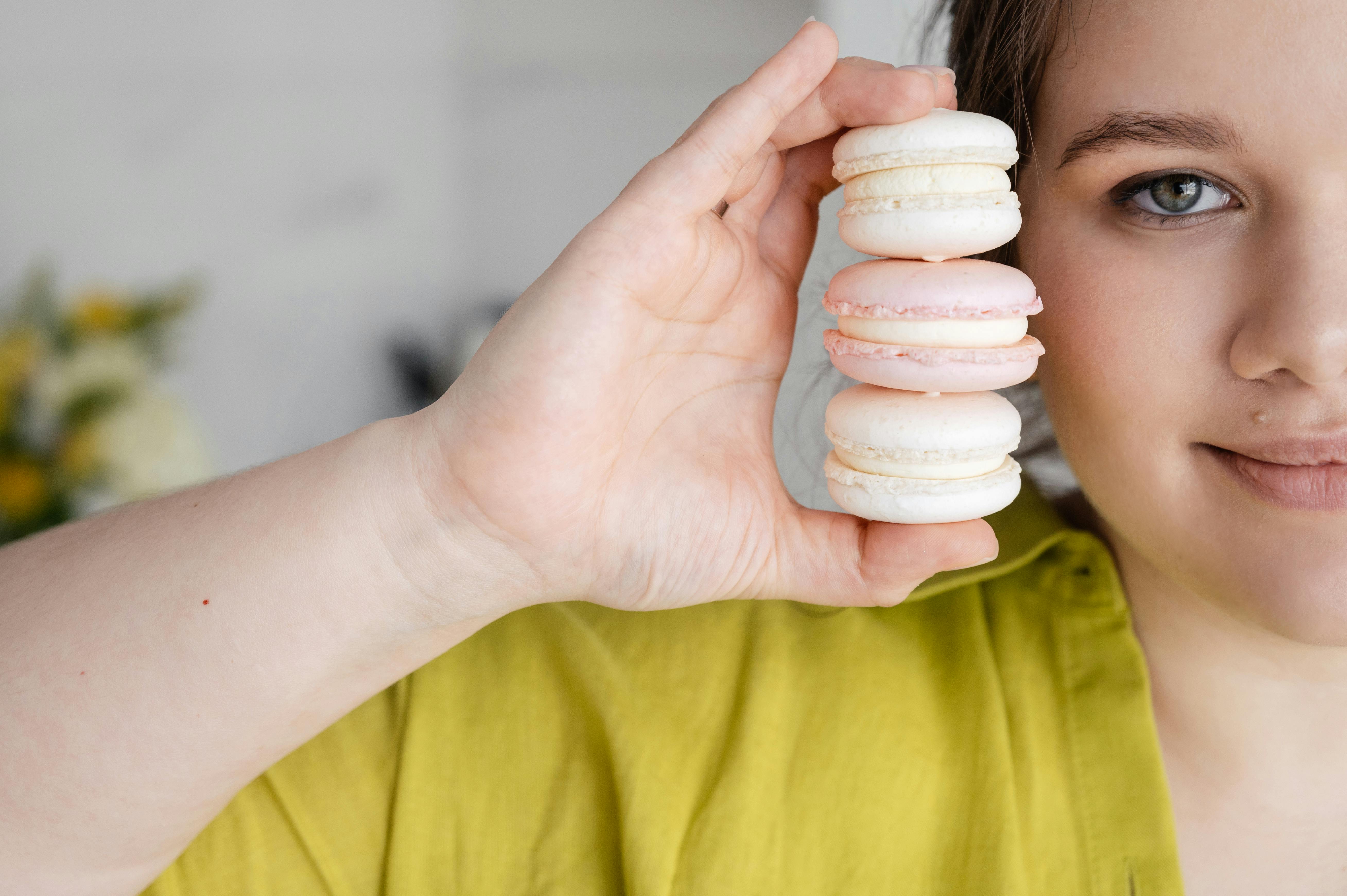 crop woman with tasty macaroons