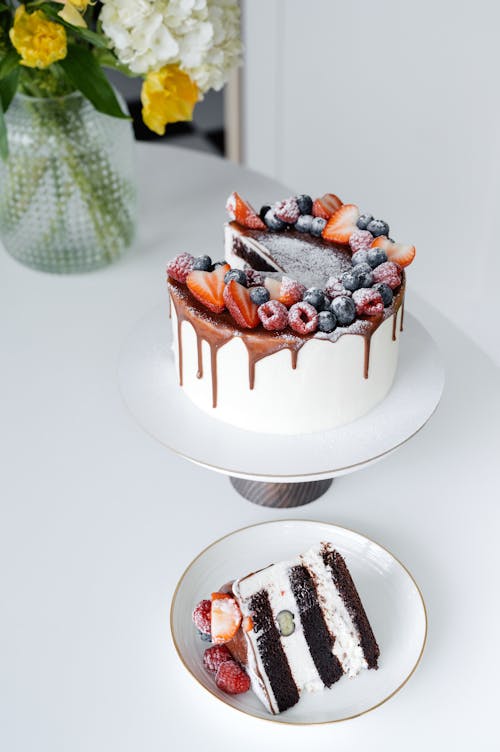 Free Appetizing cake with cream and berries served on white table Stock Photo