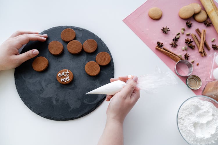 Crop Woman Decorating Gingerbread Cookies
