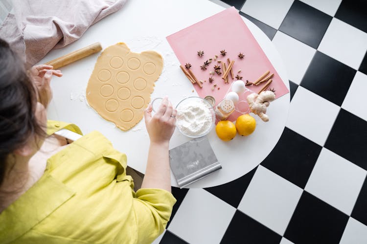 Crop Woman Preparing Dough For Christmas Cookies At Kitchen Table