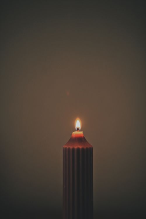 Free A close-up of a lighted candle with a soft glow creating a warm ambiance. Stock Photo