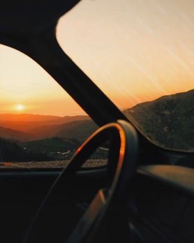 A stunning sunset view over the mountains seen from a vehicle window in Gemlik, Turkey.