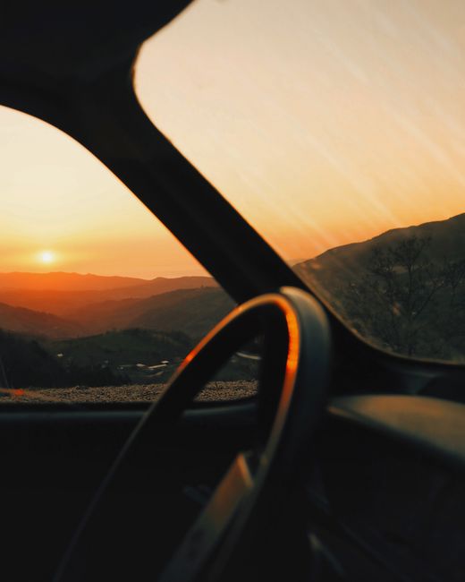 A stunning sunset view over the mountains seen from a vehicle window in Gemlik, Turkey.
