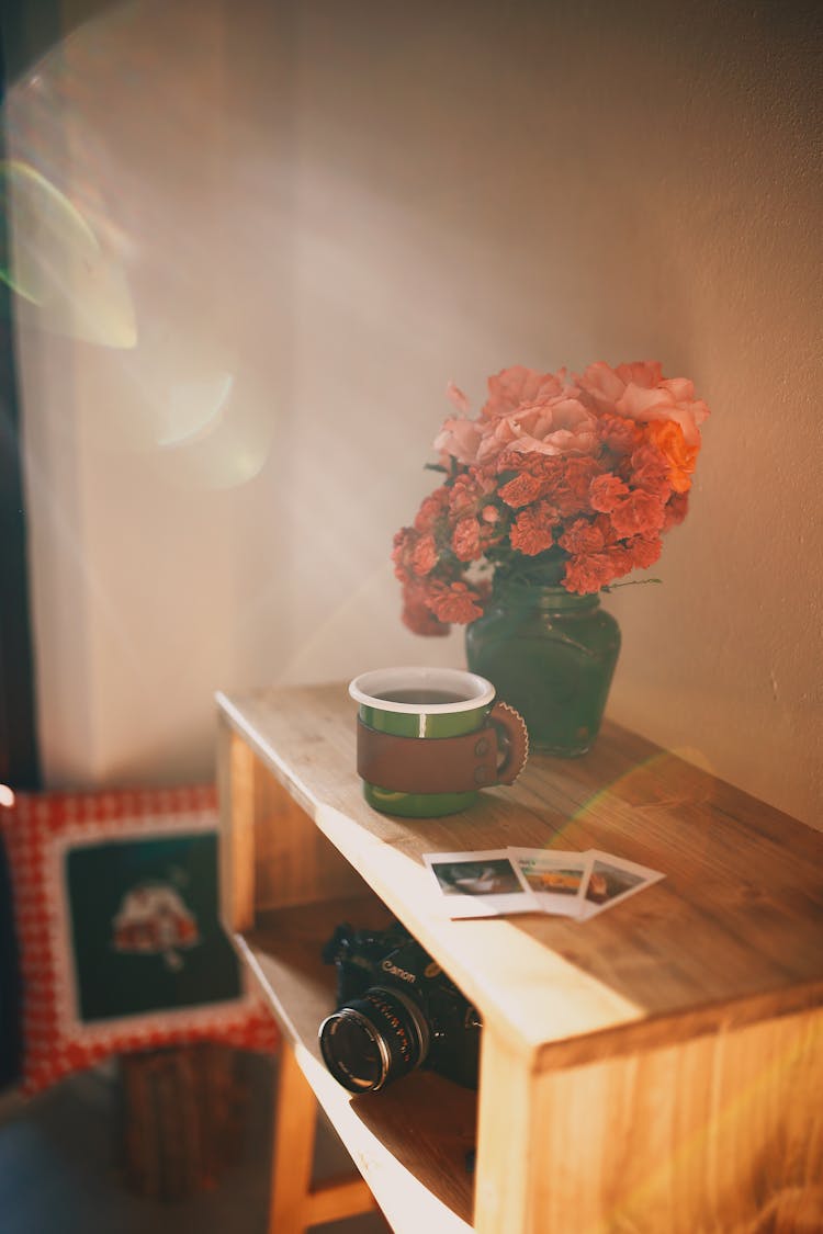 Flowers, Pictures And Tea On Cabinet