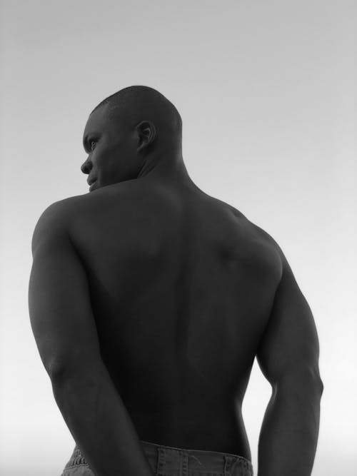 Grayscale Photo of a Topless Man