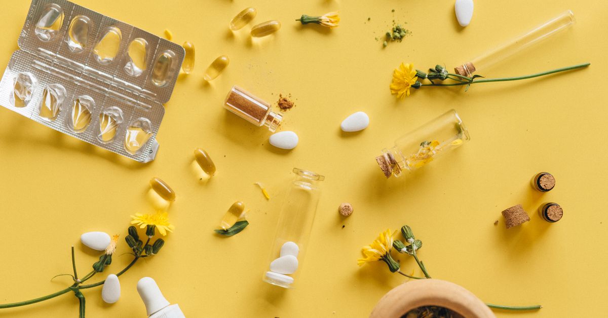 Herbal supplements and medicine capsules on a vibrant yellow background for health themes. - Evidence evidence guide for magnesium headache meta-analysis