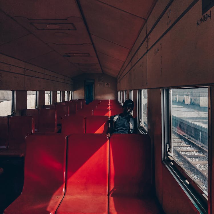 A Man Sitting Inside A Train