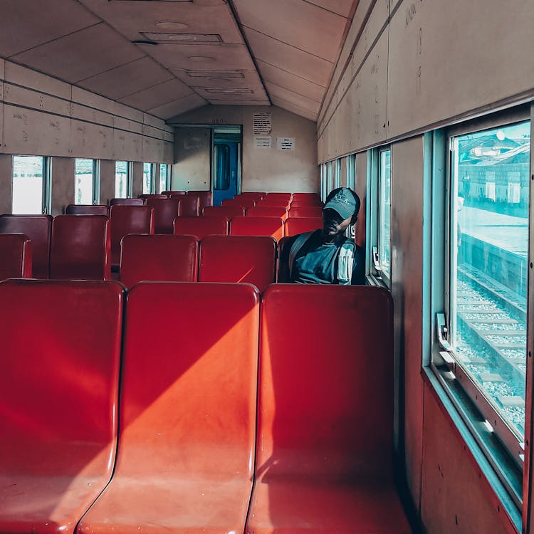 A Man Sitting Inside A Train