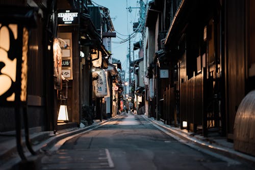 People on the Street in Between Buildings