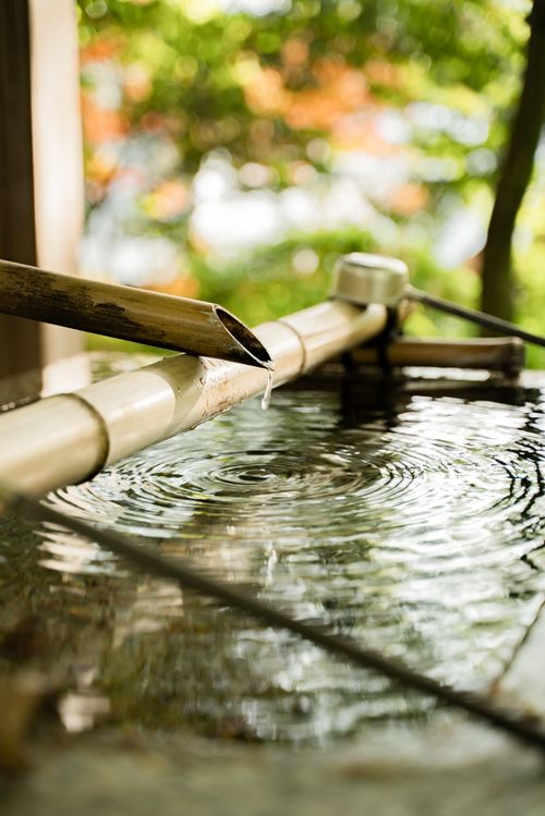 Free Beautiful capture of a bamboo water fountain dripping into a tranquil basin in Kyoto, Japan. Stock Photo