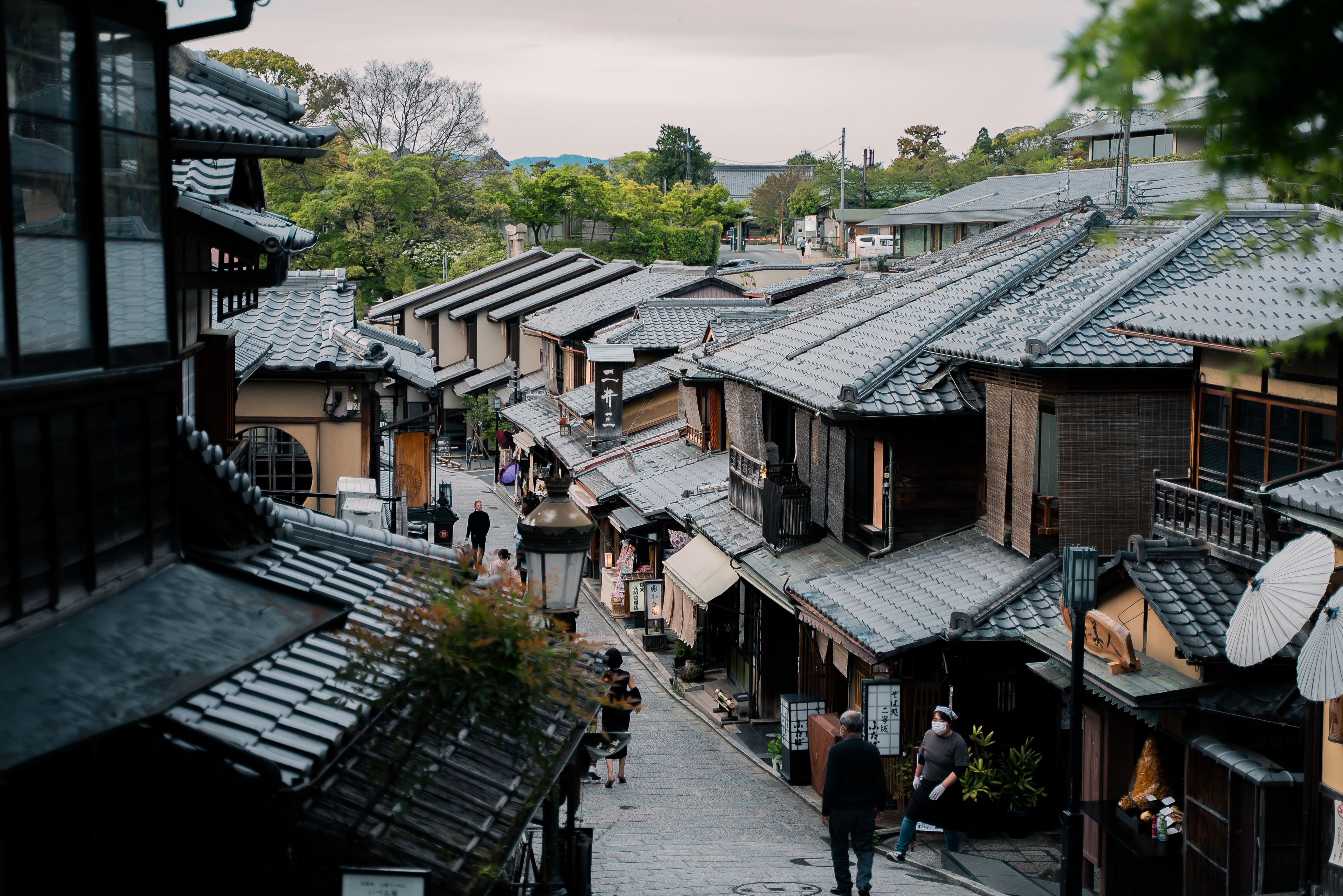Explore the traditional architecture and serene streets of Kyoto's historic district, showcasing classic Japanese wooden houses.