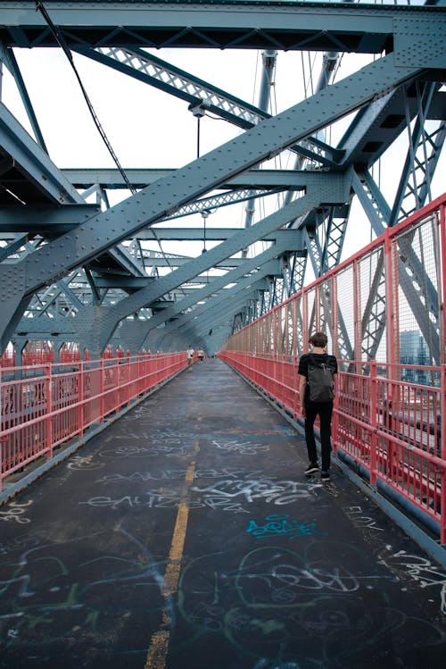 Free Backview of Man walking on a Bridge  Stock Photo