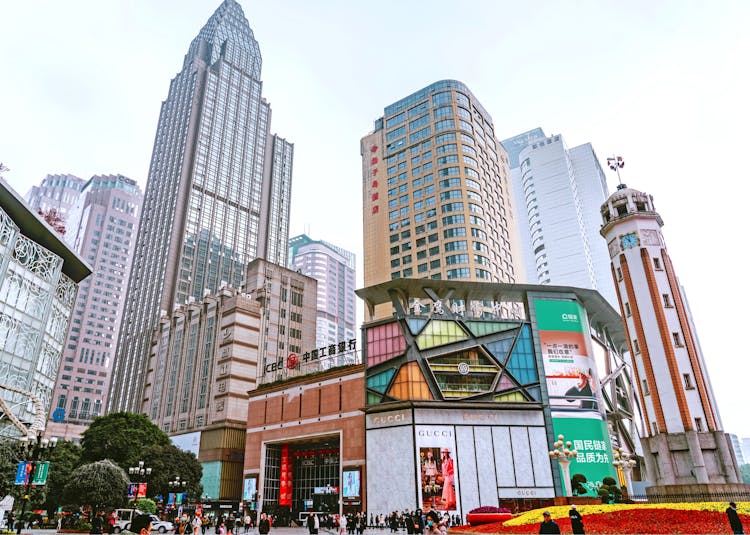 The City Skyline Of Central Chongqing, China With The People's Liberation Monument On The Side