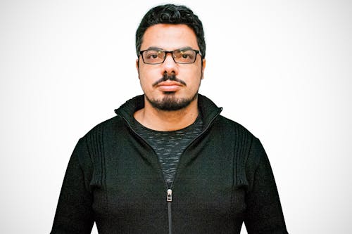 Close-Up Shot of a Bearded Man in Black Jacket and with Eyeglasses