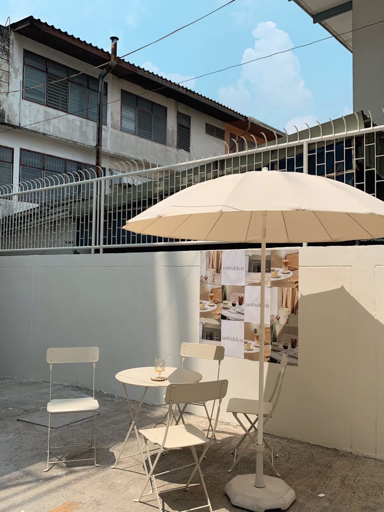 White Patio Umbrella With Table And Chairs