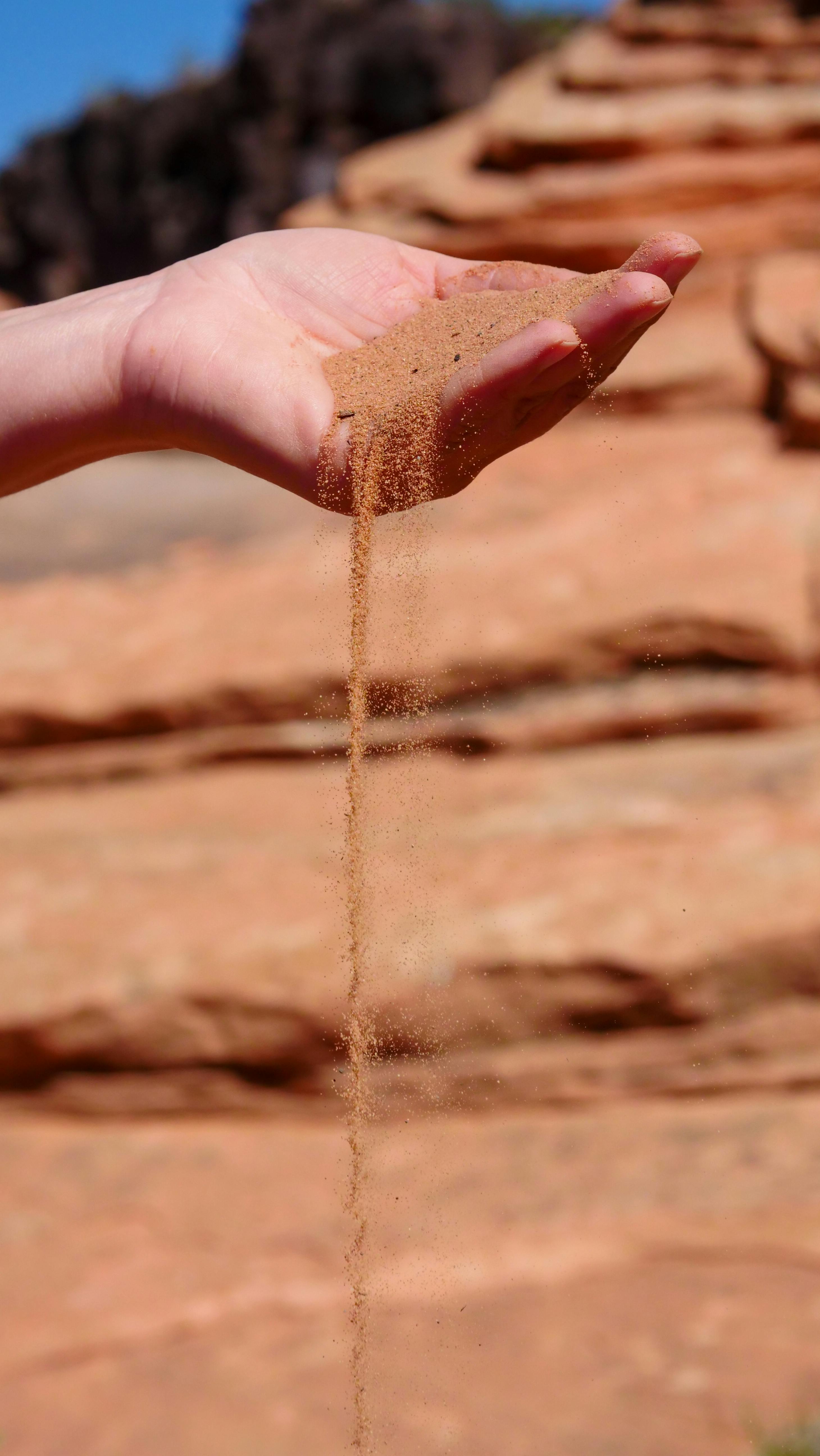 a person holding grains of sand