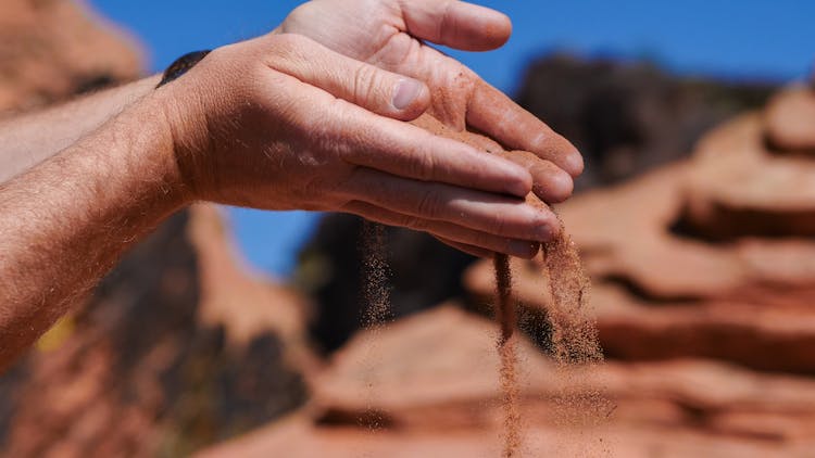 Photo Of A Person Pouring Sand