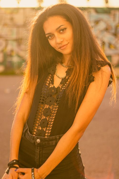Free Portrait of a fashionable young woman posing outdoors in Valencia, Spain. Stock Photo