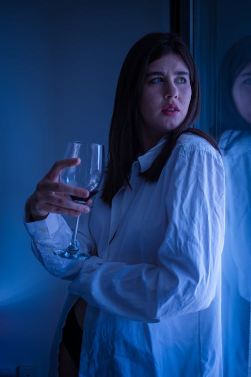 Woman Holding a Glass Of Wine Looking Away