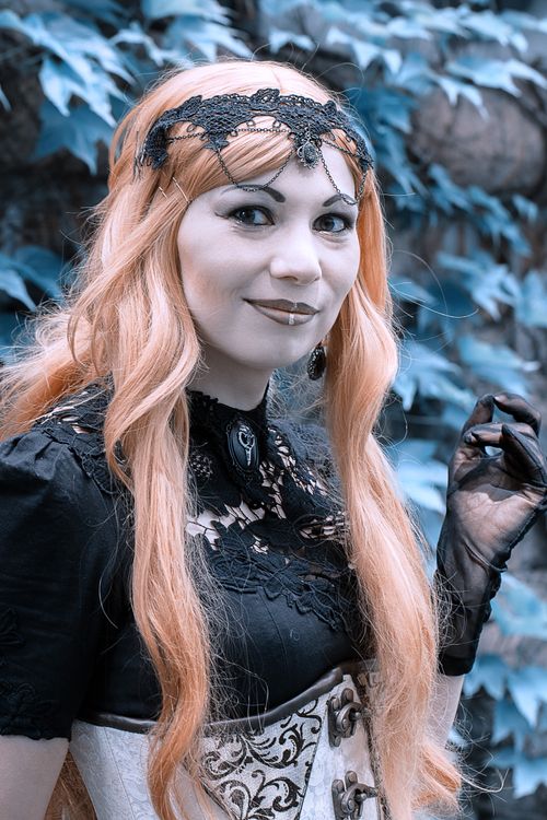 Free Captivating gothic-style portrait of a woman with intricate makeup and accessories outdoors. Stock Photo
