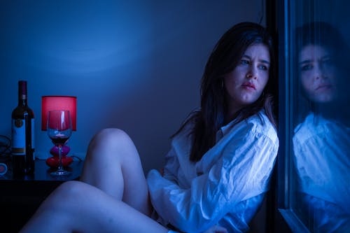 Free A Sad Woman Looking out the Window Stock Photo