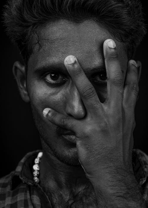 Free Grayscale Photo of a Man Covering His Face with His Hand Stock Photo