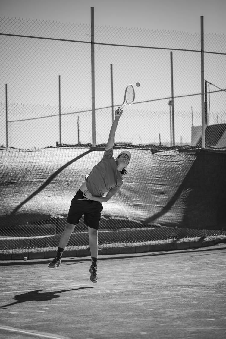 Grayscale Photo Of A Person Playing Tennis