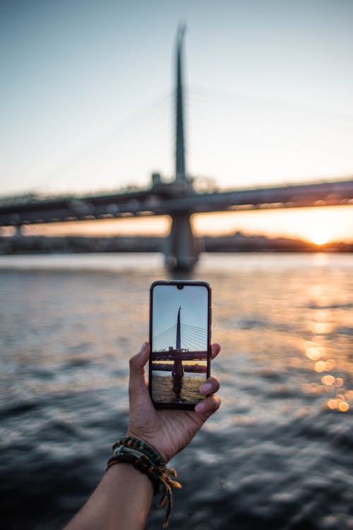 Free Close-Up Shot of a Person Taking Photo of a Bridge  Stock Photo