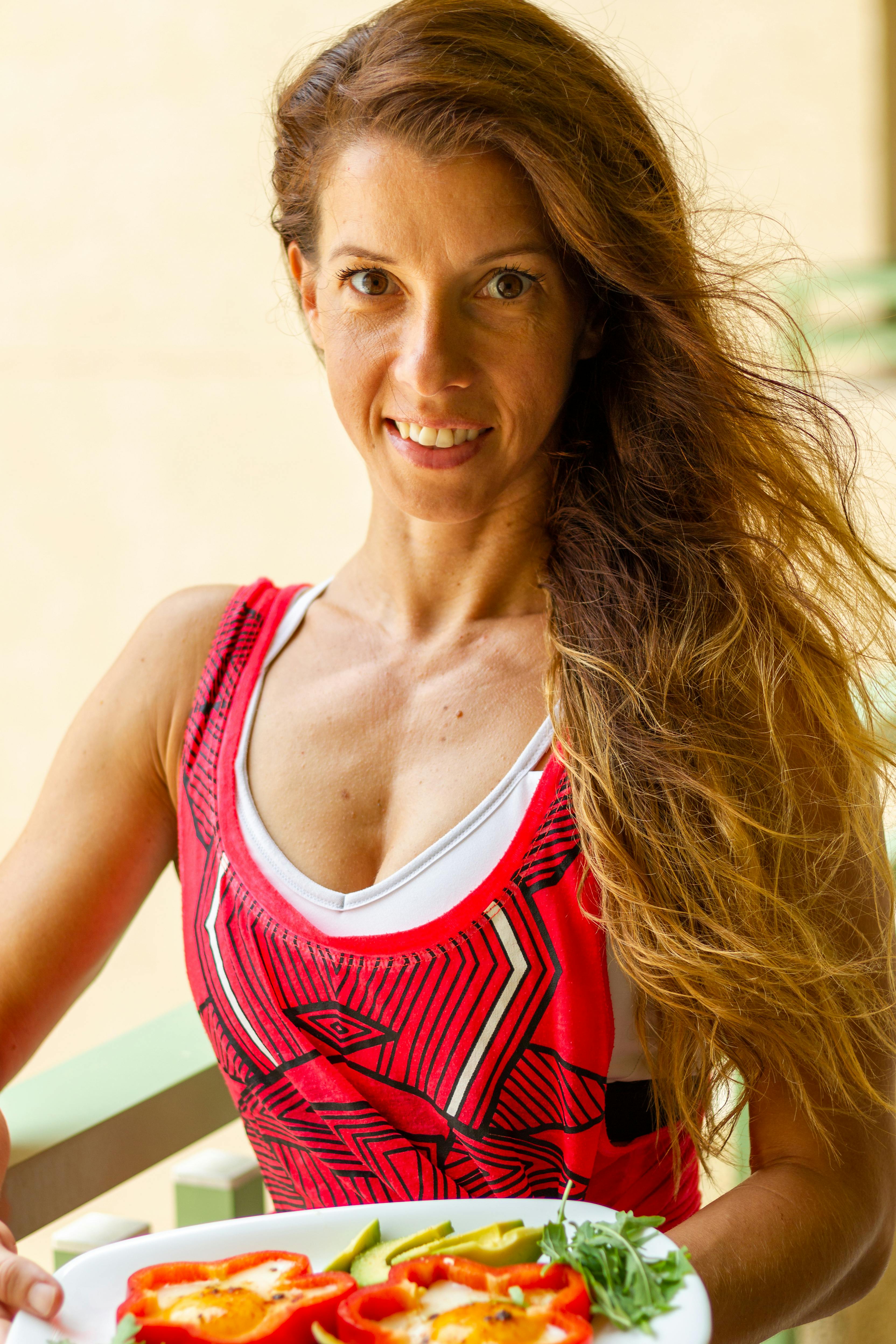 woman in tank top holding a plate