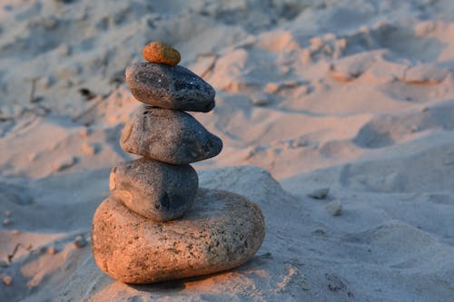 Free Stones Stacked on the Sand Stock Photo