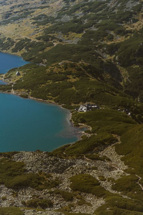 Free Aerial view of a secluded mountain lake and lush hills in the Tatry region, Poland. Stock Photo