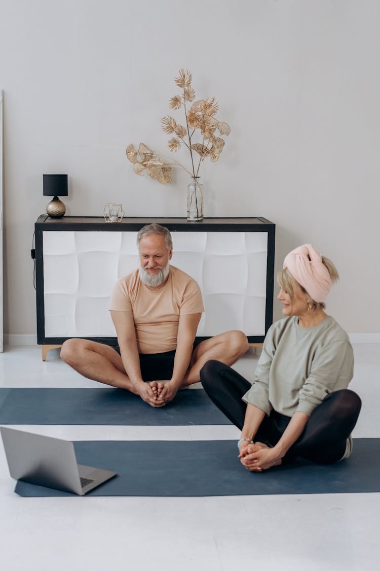 Elderly Couple Exercising Together At Home