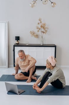 Senior couple engaging in a home yoga session, showcasing a healthy lifestyle.