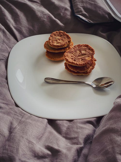 Sweet homemade pancakes served on plate on soft bed
