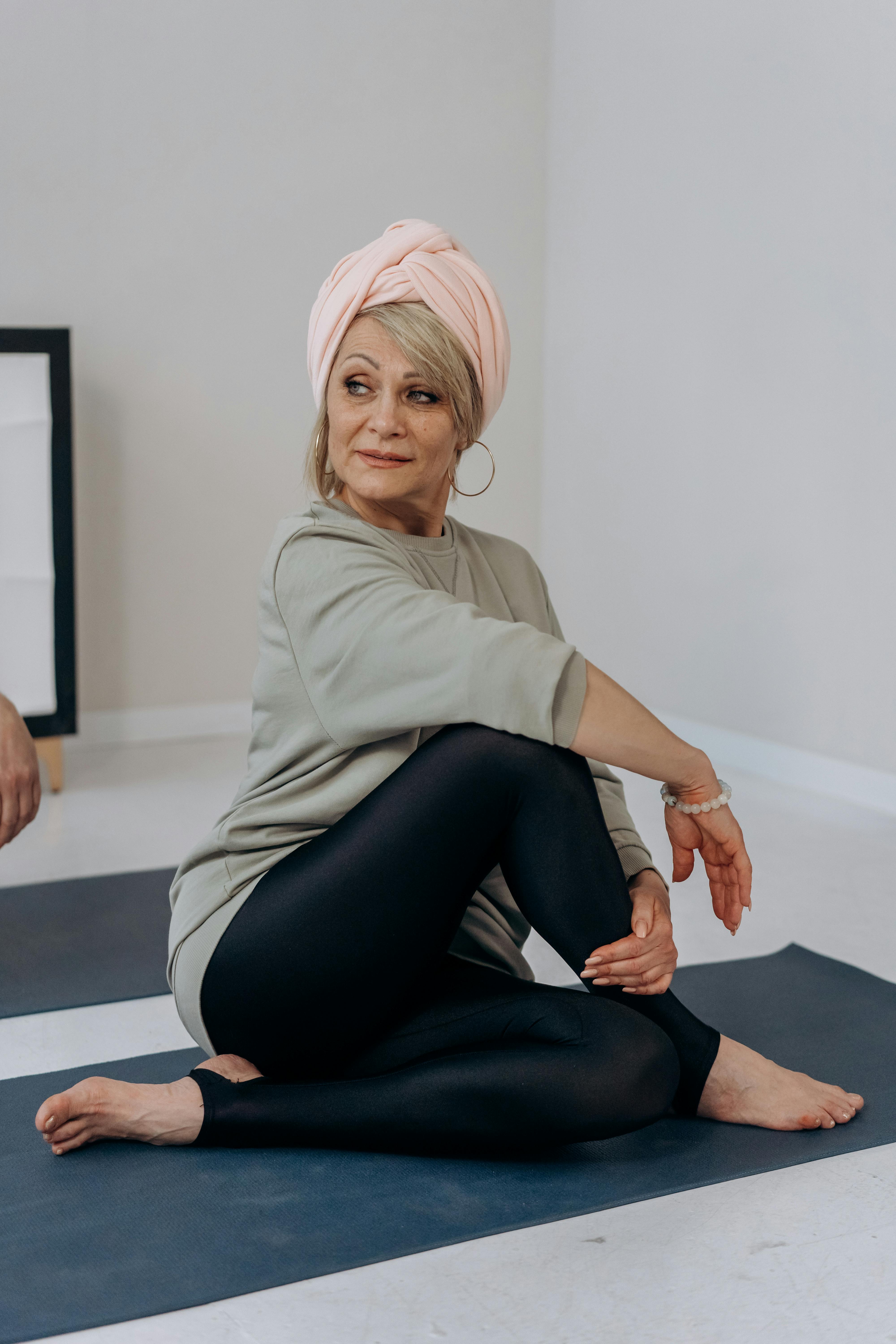 woman sitting on a yoga mat