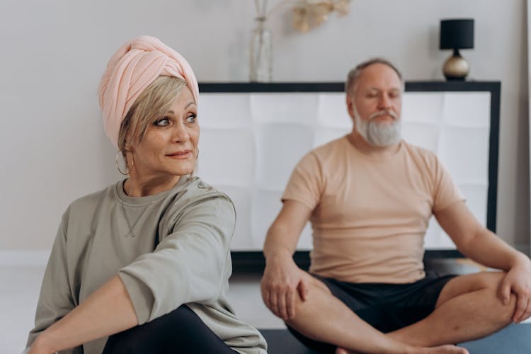 An Elderly Man And Woman Doing Yoga