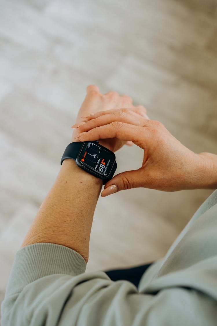 Person Looking At Her Black Smartwatch