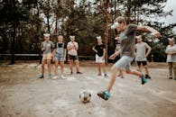 A Group of People Wearing Improvised Eye Cover Made of Disposable Cups while Playing Soccer