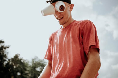 A Man Wearing Improvised Eyeglasses Made of Disposable Cups with a Hole