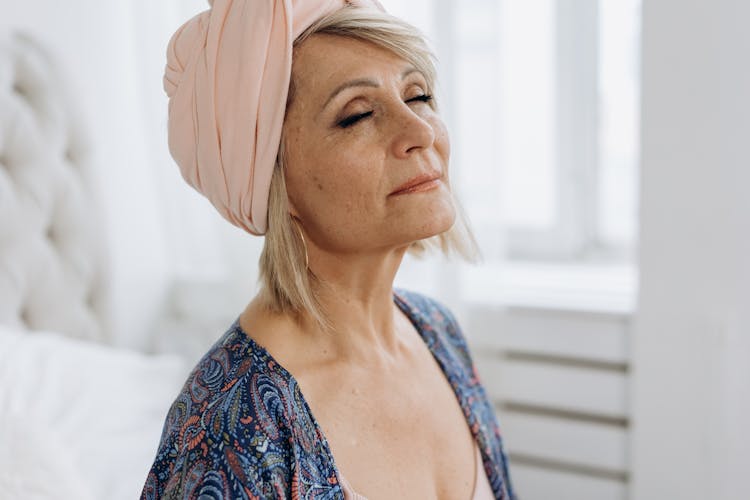 A Mature Woman With Pink Headscarf  Meditating