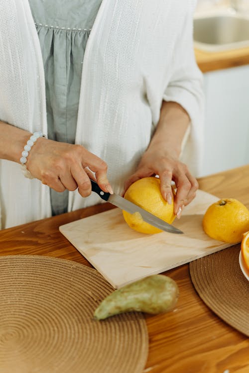 A Person Slicing a Lemon