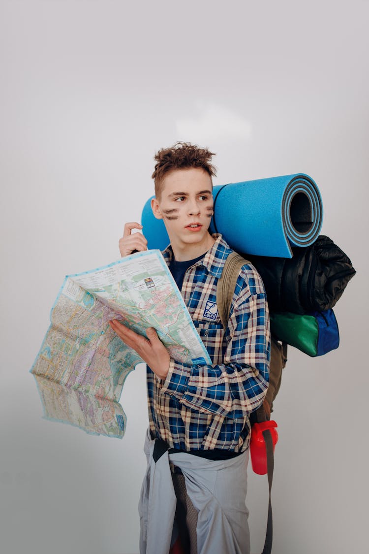 A Backpacker Holding A Map