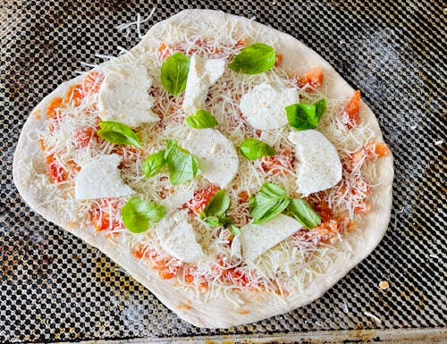 Raw Pizza With Basil and Mozzarella