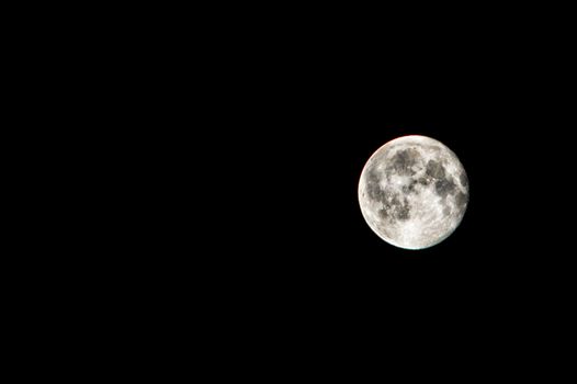 A detailed shot of a full moon against a clear, black sky captured in Morelia, Mexico.