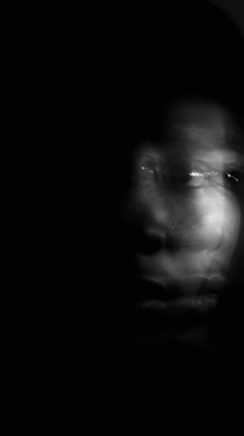 Free Human face peeping out of darkness Stock Photo
