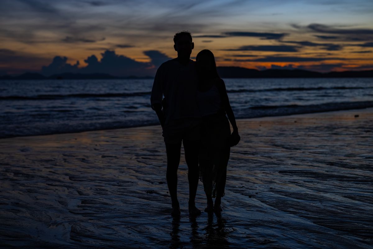 Couple silhouette beach sunset