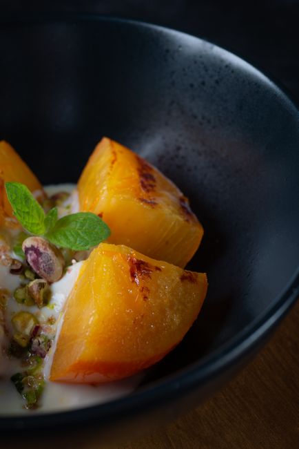 Fuyu persimmon wedges roasted until caramelized at the edges.